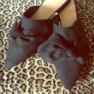 ‘A new day’ black bow mules.